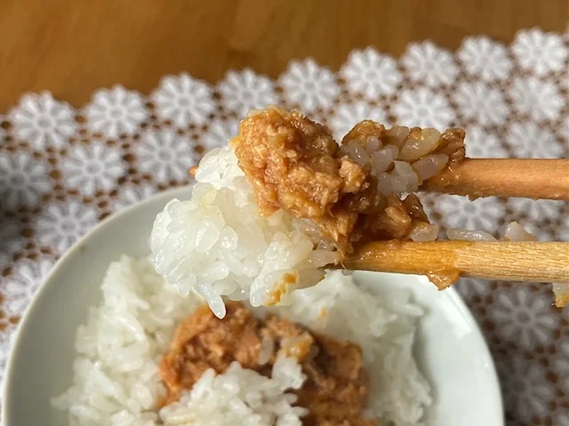 『3COINS』で購入できる「大人の鮭フレーク 香味オイル漬け」、食べている手元