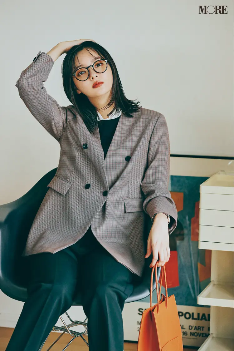 チェック柄のノーカラージャケットを着た新川優愛