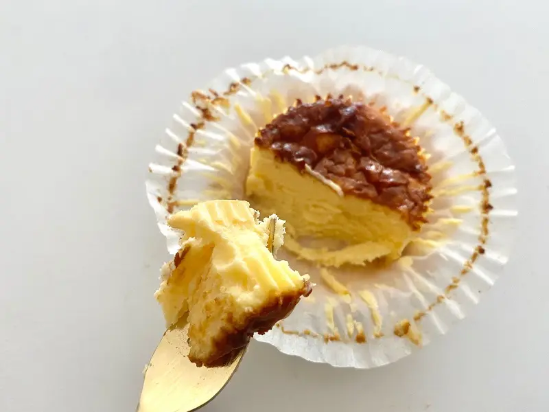 『ローソン』の「バスチー -バスク風チーズケーキ-」をスプーンですくった写真