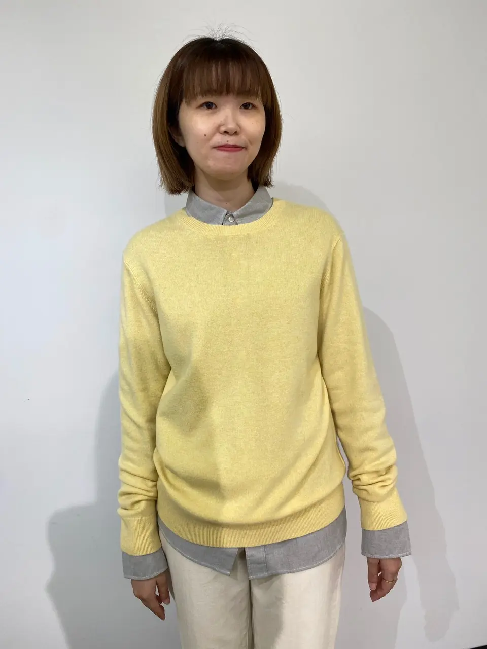イエローニットの中にグレーのシャツを着て「自分に似合う色」に