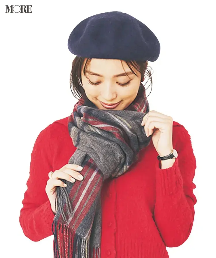 顔の下でストールの端を輪の中に入れて結ぶ女性