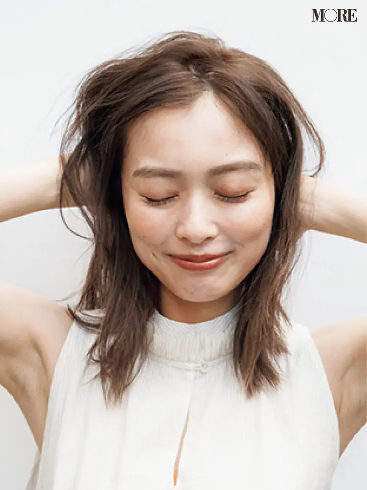 梅雨のポンパドールヘアアレンジでムースを髪につける女性